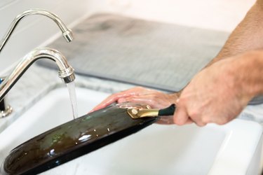 cleaning pan in kitchen sink