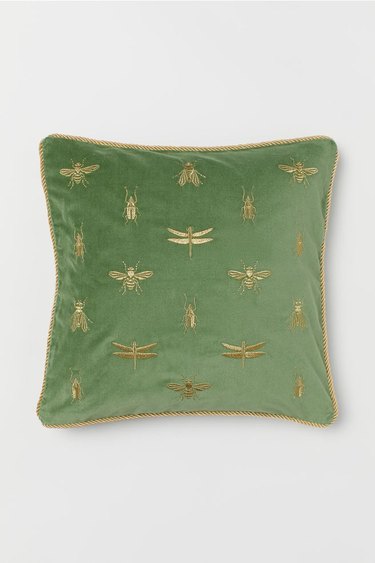 green velvet pillow with gold embroidered insects