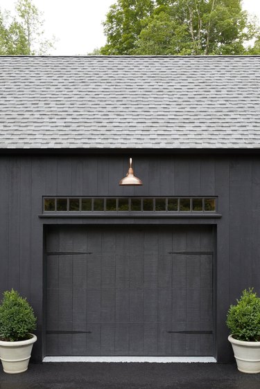 modern black exterior with brass exterior garage lighting