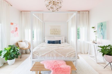pink bedroom with white walls and blush ceiling and four-poster bed