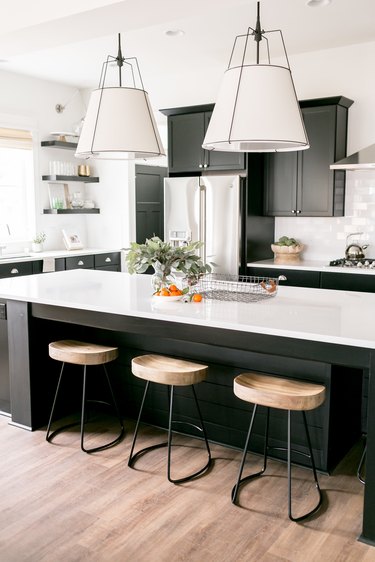 pendant kitchen ceiling light over island with black cabinets