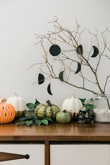 Place a found tree branch in a jar filled with rocks to create your Halloween centerpiece.