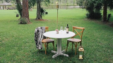 Brass pipe torch in front of outdoor table