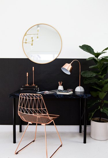small home office with black color blocking and rose gold wire frame chair