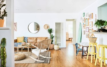 colorful living room with leather sofa and rocking chair on area rug