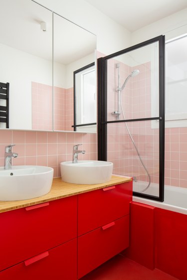pink and red basement bathroom idea with window