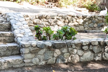 a stone retaining wall with stone steps
