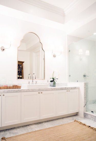white basement bathroom idea with mirror and jute rug