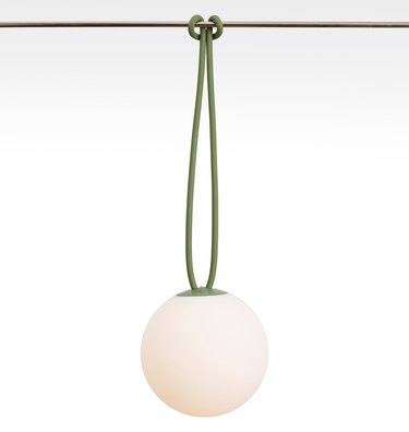 White globe light hanging from green rope