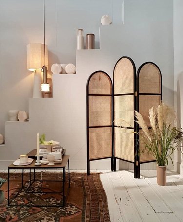room divider idea for the living room with curved cane folding screen with black trim
