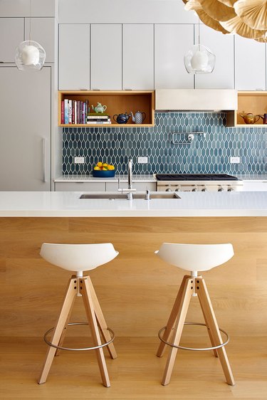 modern kitchen with teal tile backsplash