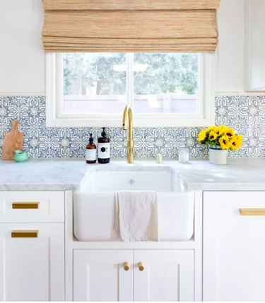 moorish tile backsplash in kitchen with farmhouse sink and Roman shade