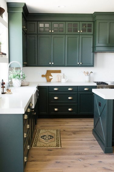 modern kitchen with green cabinets