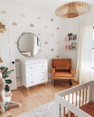 neutral nursery idea with pendant light hanging from ceiling and warm tones throughout