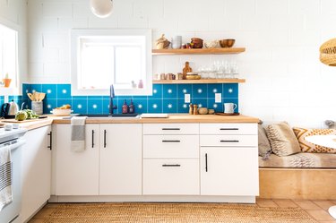 Blue and white star backsplash tile in white and wood kitchen