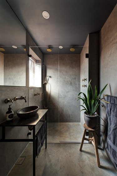 concrete bathroom with aged bronze shower bathroom fittings