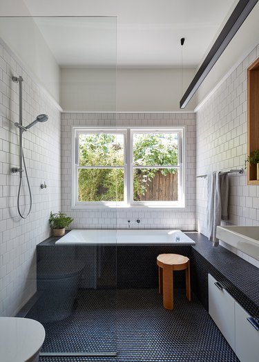 polished chrome bathroom fittings with white subway tile on walls