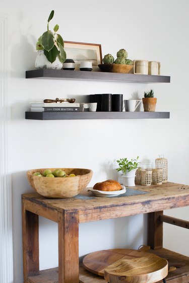 The butcher block table with floating shelves above.