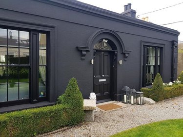 black home exterior idea with greenery