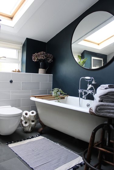 bathroom fittings with vintage-inspired tub filler and handshower with blue accent wall