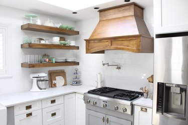 white rustic kitchen with copper vent hood and open shelving