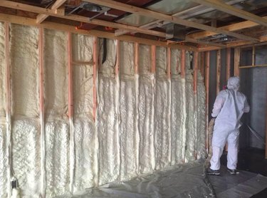 Spraying foam insulation in the basement.