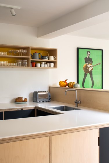 plywood kitchen backsplash idea with stainless steel sink and white countertops