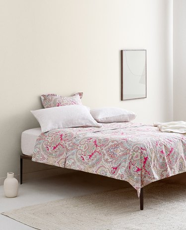 bed with a paisley duvet