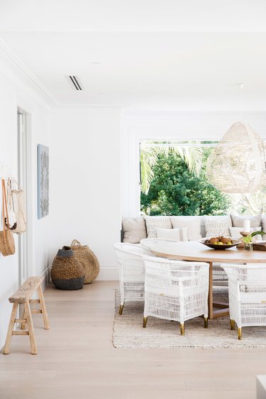 white coastal farmhouse dining room with rattan dining chairs
