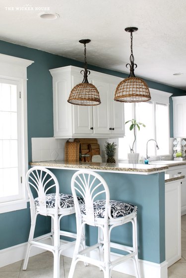 teal walls with white cabinets