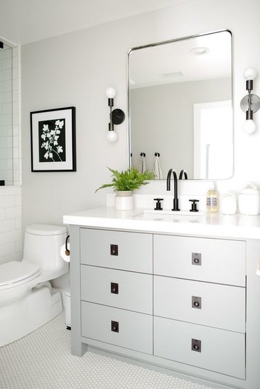small bathroom lighting idea with wall sconces and gray cabinets