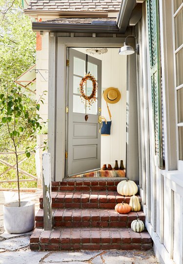 squash and fall pumpkins on brick steps