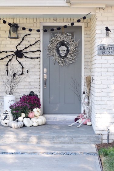 fall porch decor for Halloween with gray door