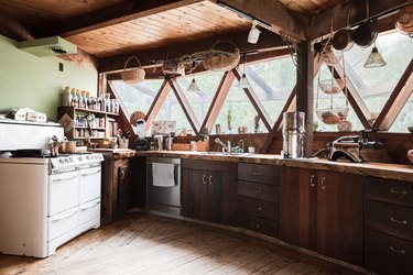 rustic kitchen with hanging baskets and mounted lighting