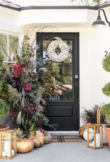 fall porch decor with flowers and cotton wreath