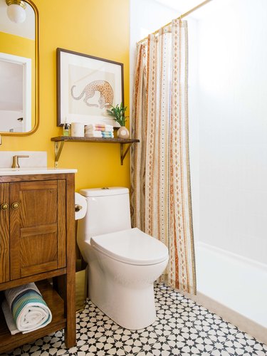 yellow bohemian bathroom ideas with wood vanity cabinet and patterned floor tile