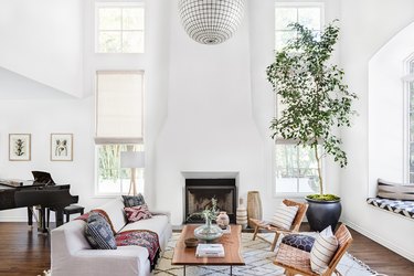 A tall fireplace in a white living room