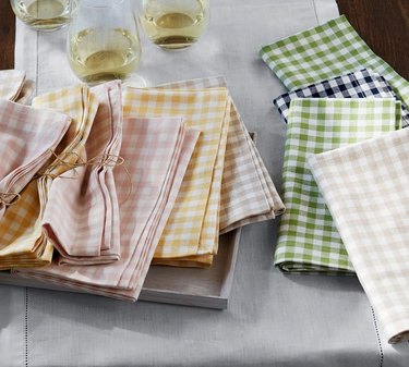 view of table with gingham napkins and wine glasses