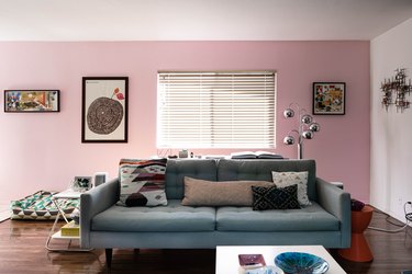 color idea for midcentury-inspired living room with pink accent wall
