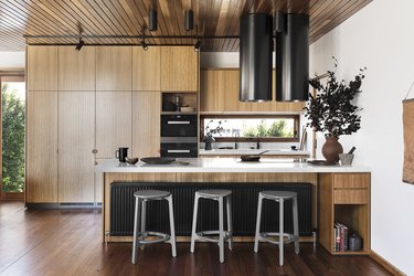 minimalist kitchen with track lighting and wood cabinets