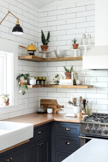 Wood kitchen countertop with blue cabinets