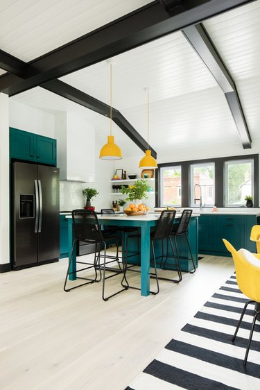 teal and yellow kitchen color idea with black ceiling beams