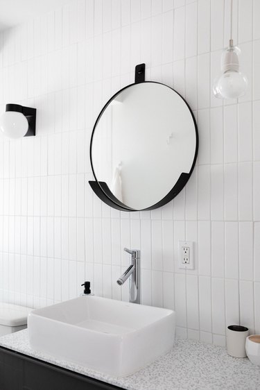 vessel bathroom sink with white wall tile and modern mirror