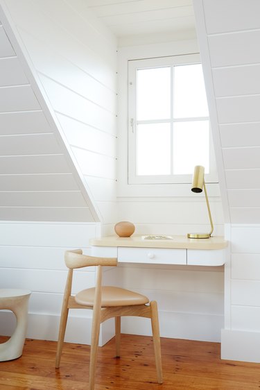 bedroom with a home office setup in a nook under the window