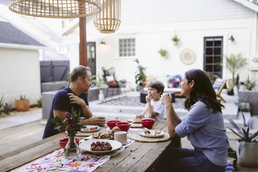 Gary, Ronan and Lisa dine al fresco at a table built by Gary.