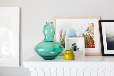 Objects and art on the mantel.