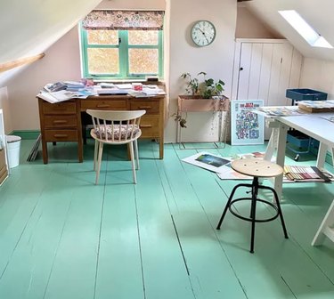 Home Office for Two Attic office with painted turquoise wood floors, vintage desk, stool, wall clock.