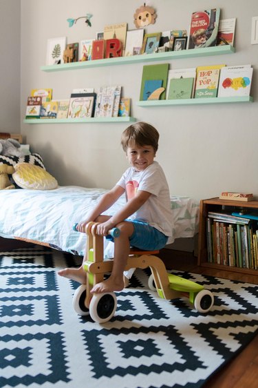 Ronan in his room with shelving made by Gary.