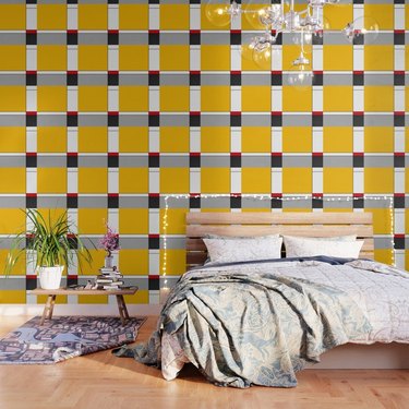 red yellow and blue Bauhaus wallpaper in bedroom