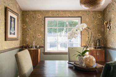 Dining room with floral wallpaper and wood storage cabinets